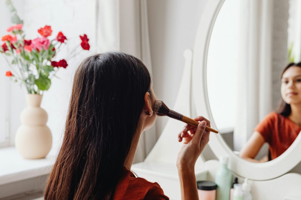 Woman doing makeup- party makeup by disha